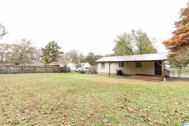 view of yard featuring a wooden deck and central AC