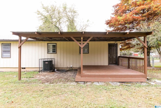 back of house with central AC unit, a yard, and a deck