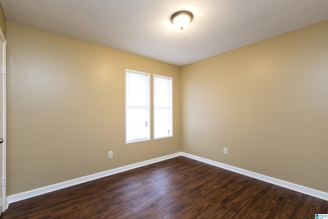 unfurnished room featuring dark hardwood / wood-style floors and a textured ceiling