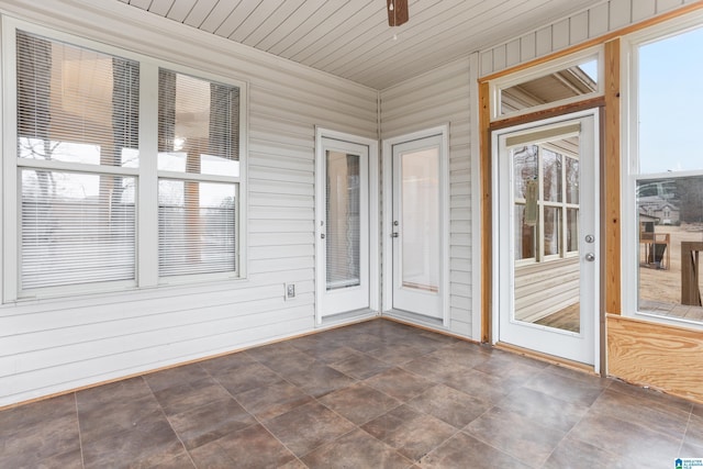 unfurnished sunroom with wooden ceiling and ceiling fan