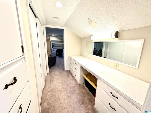 bathroom featuring lofted ceiling and a textured ceiling