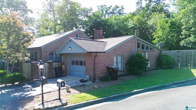 view of front of home with a garage and a front lawn