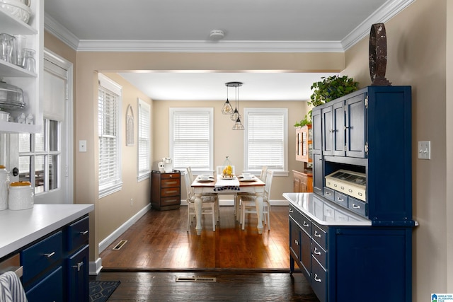 kitchen with dark hardwood / wood-style flooring, hanging light fixtures, crown molding, and blue cabinets