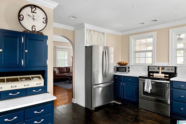 kitchen featuring blue cabinetry, ornamental molding, stainless steel appliances, and dark hardwood / wood-style floors