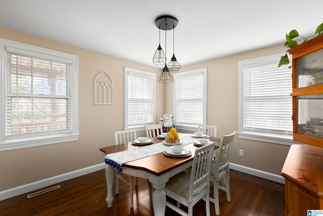 dining area featuring dark wood-type flooring