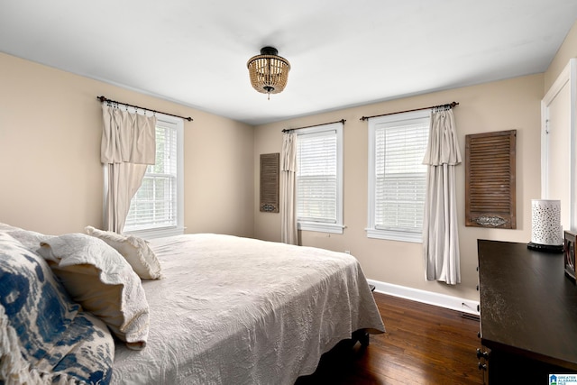 bedroom with dark hardwood / wood-style floors