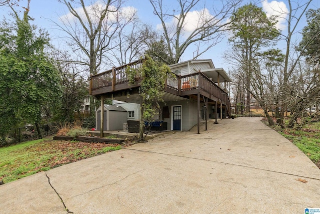 view of home's exterior featuring a deck and a storage shed