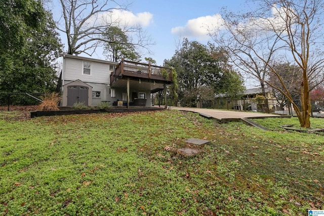 back of property with a lawn, a deck, and a storage shed