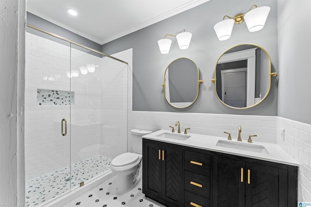 bathroom with toilet, a shower with shower door, crown molding, tile walls, and vanity