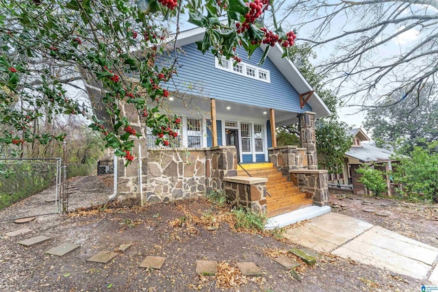 rear view of property featuring a porch