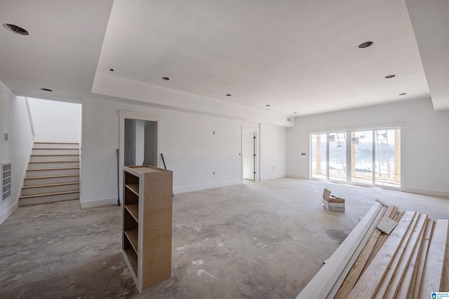 unfurnished living room with concrete flooring