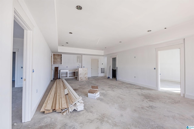 unfurnished living room featuring concrete floors