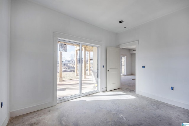 unfurnished room featuring concrete flooring