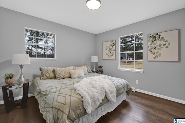 bedroom with dark wood-type flooring