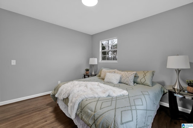 bedroom with dark hardwood / wood-style flooring