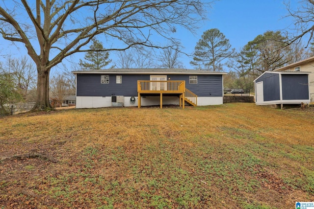 back of property featuring a storage shed, a yard, and a deck