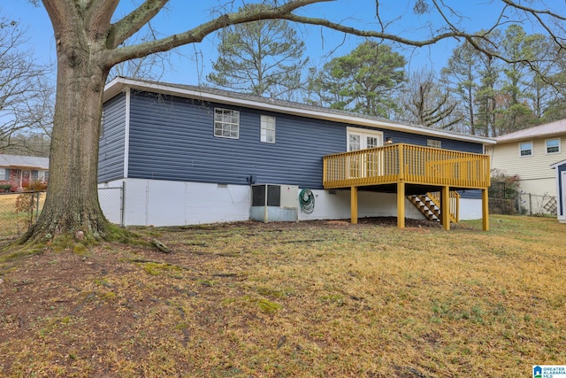 back of house featuring cooling unit, a wooden deck, and a yard