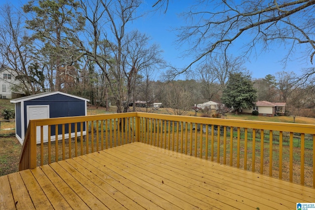 wooden terrace with a shed and a lawn