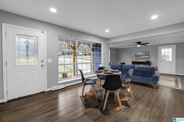 dining room with ceiling fan and dark hardwood / wood-style flooring