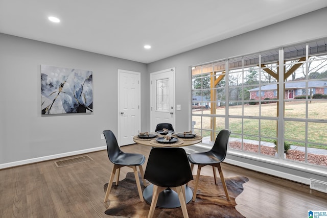 dining space with hardwood / wood-style flooring