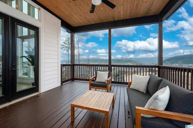 deck with ceiling fan and an outdoor living space