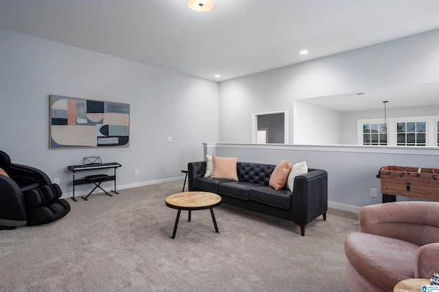 living room with recessed lighting, light colored carpet, and baseboards