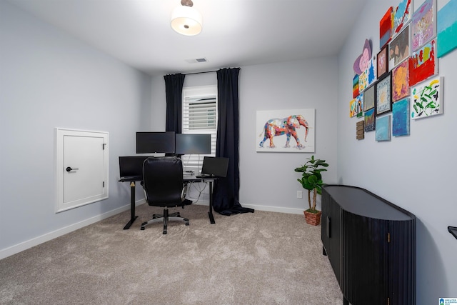 carpeted office with visible vents and baseboards