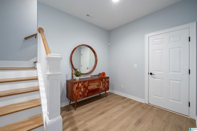 interior space featuring wood finished floors, visible vents, and baseboards