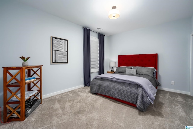 carpeted bedroom featuring visible vents and baseboards