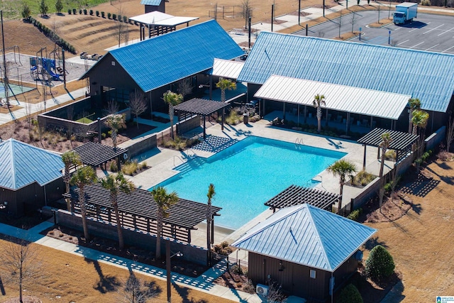 community pool featuring a patio area, fence, and a pergola