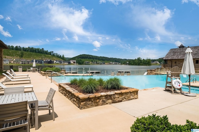 community pool featuring a patio and a water view