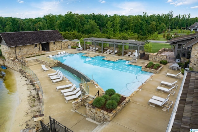 pool with a patio, fence, and a pergola