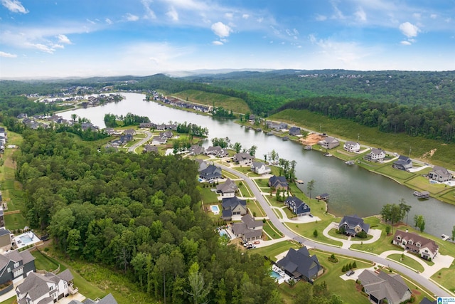 bird's eye view with a water view, a wooded view, and a residential view