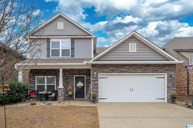 view of front of home featuring a porch, a garage, and a front lawn