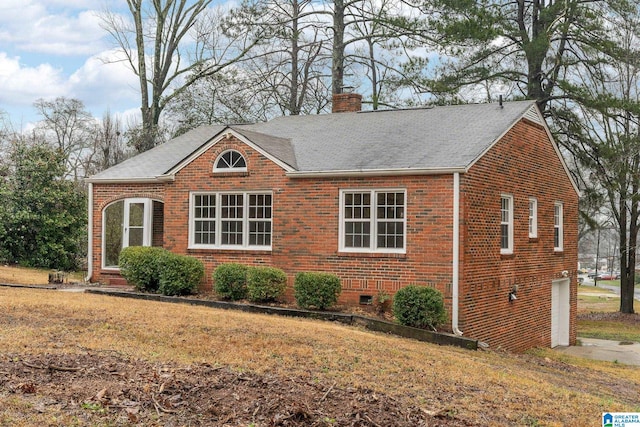 view of front of home featuring a garage and a front lawn