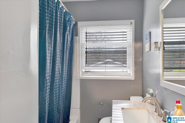 full bathroom featuring vanity, shower / bath combo, and toilet