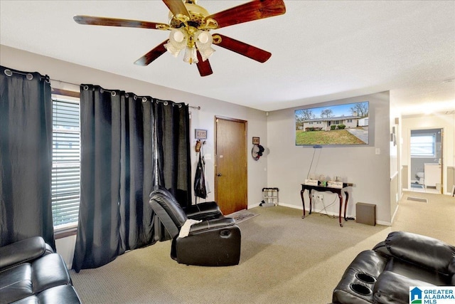 carpeted living room featuring ceiling fan