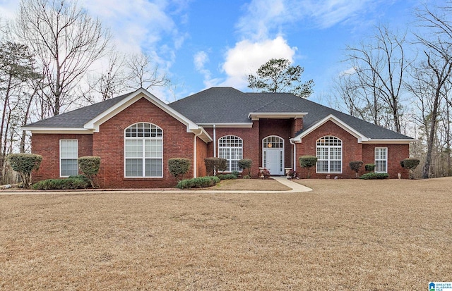 ranch-style home featuring a front yard