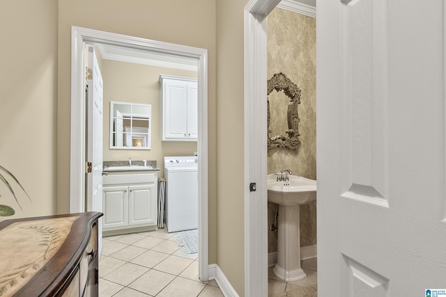 bathroom with ornamental molding, tile patterned floors, washer / clothes dryer, and sink