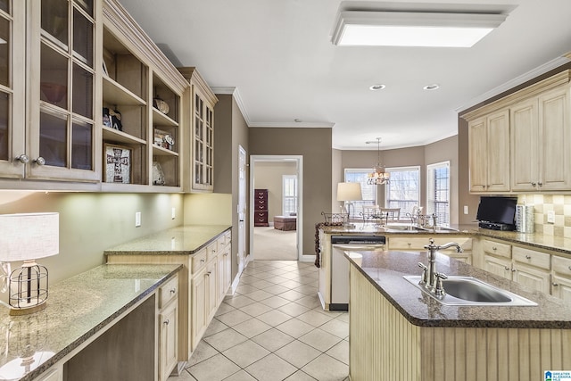 kitchen with decorative light fixtures, dishwasher, an island with sink, sink, and ornamental molding