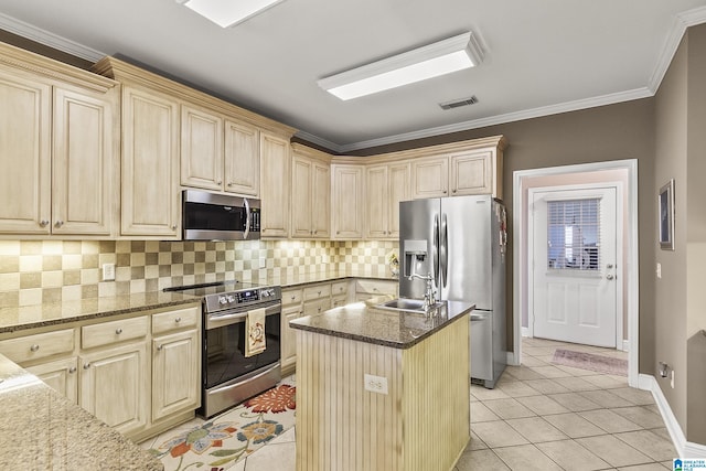 kitchen with a kitchen island, light tile patterned flooring, appliances with stainless steel finishes, and dark stone counters