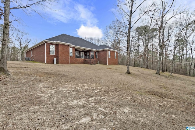 back of house with central AC unit