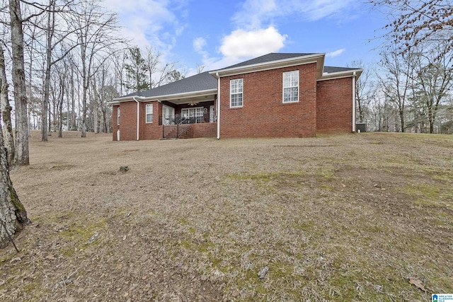 rear view of property featuring a lawn