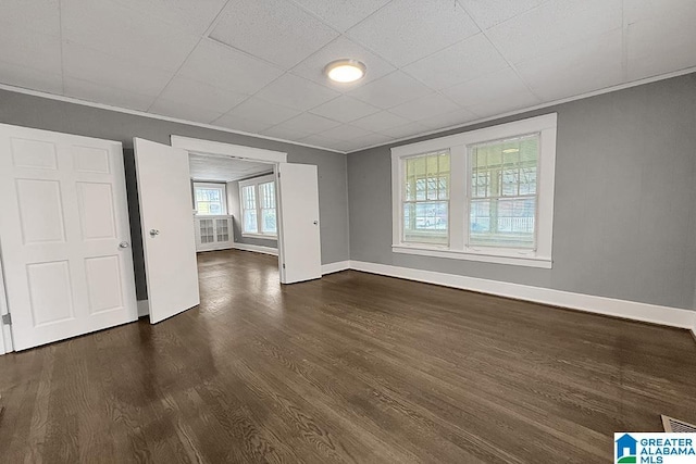 interior space featuring dark hardwood / wood-style flooring and ornamental molding