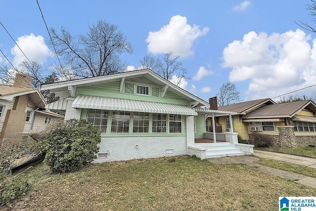 bungalow-style house featuring a front yard