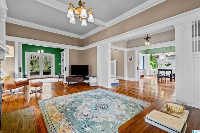 living room with an inviting chandelier, plenty of natural light, and wood-type flooring