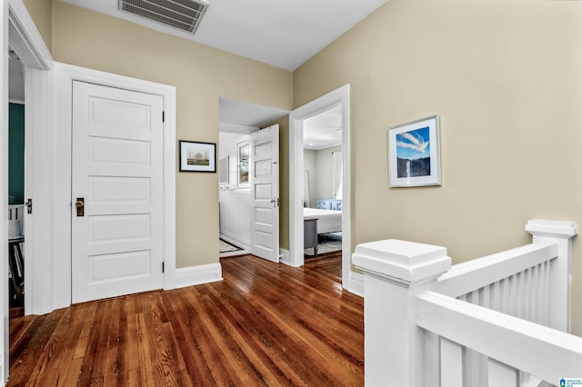 corridor featuring dark hardwood / wood-style flooring