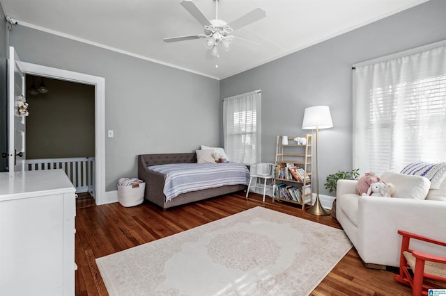 bedroom featuring crown molding, dark hardwood / wood-style floors, and ceiling fan