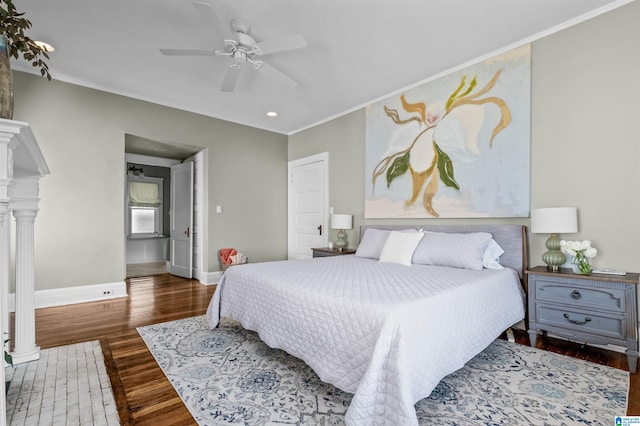 bedroom featuring ceiling fan, ornamental molding, and dark hardwood / wood-style floors