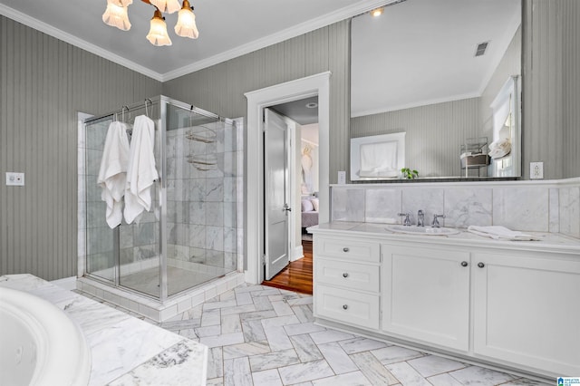 bathroom with separate shower and tub, vanity, crown molding, and an inviting chandelier